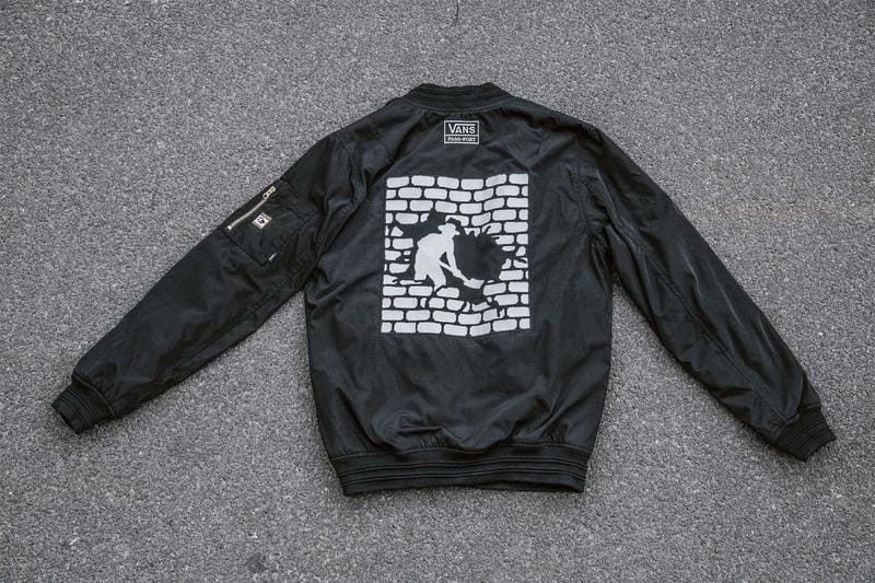 black vans passport bomber jacket, digging man graphic print in the back, cement background