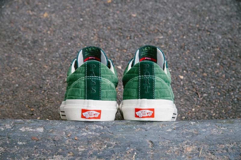 green vans shoes back view, white sole, vans red logo, cement